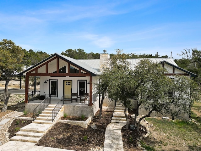 631 Lakeside Dr, Wimberley, TX 78676 - view of front of house with stairs, a porch, and a chimney
