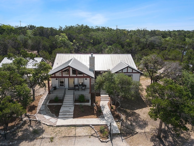 631 Lakeside Dr, Wimberley, TX 78676 - view of front of property featuring a forest view, fence, stairway, a porch, and metal roof