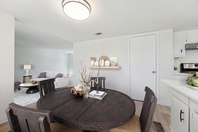 8011 Scotland Yard, Austin, TX 78759 - dining space with light wood-type flooring and baseboards
