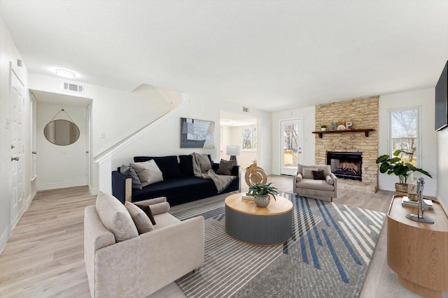 8011 Scotland Yard, Austin, TX 78759 - living room with wood finished floors, stairway, a fireplace, and baseboards