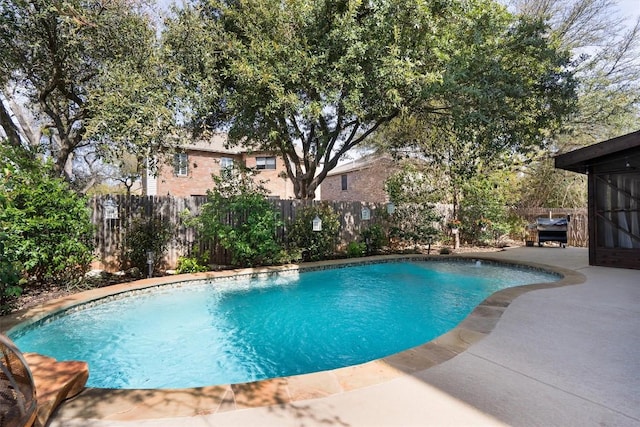 view of pool with a fenced backyard and a patio area