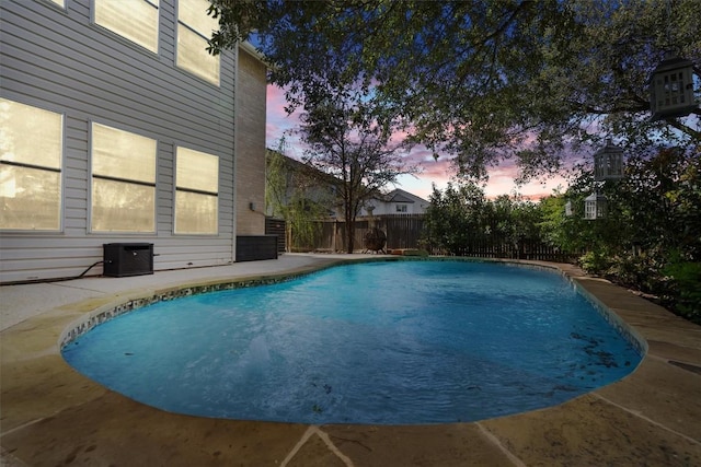 view of swimming pool featuring a fenced backyard, central AC, and a patio area