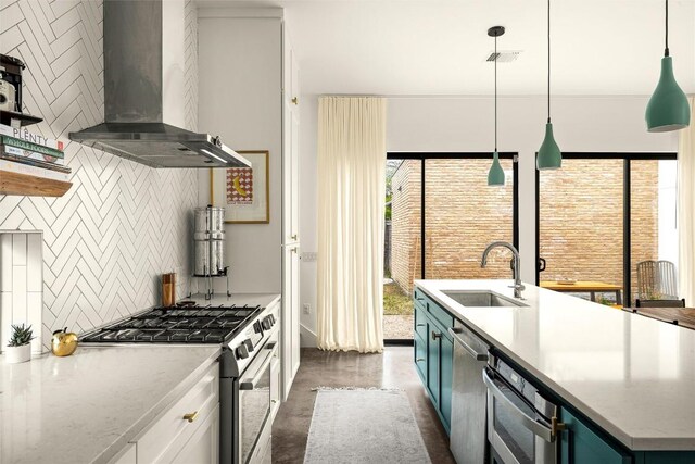 2012 Arpdale St, Austin, TX 78704 - kitchen with wall chimney range hood, appliances with stainless steel finishes, tasteful backsplash, an island with sink, and finished concrete flooring