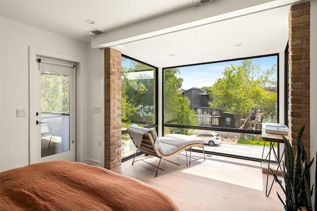 2012 Arpdale St, Austin, TX 78704 - bedroom with wood finished floors, access to exterior, and expansive windows