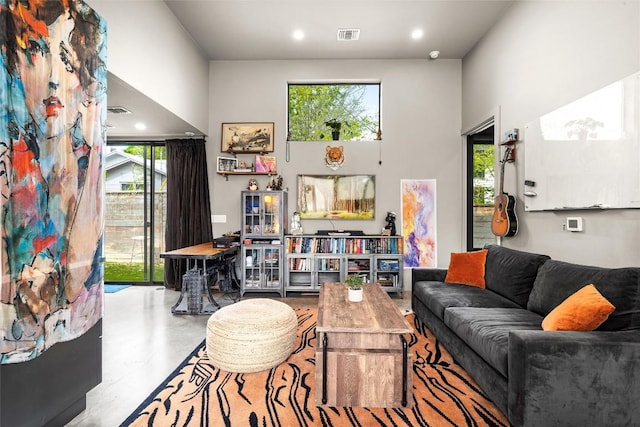 2012 Arpdale St, Austin, TX 78704 - living area featuring concrete flooring and a towering ceiling