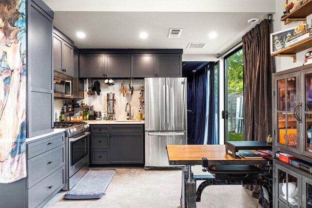 2012 Arpdale St, Austin, TX 78704 - kitchen featuring stainless steel appliances, light countertops, decorative backsplash, gray cabinets, and recessed lighting