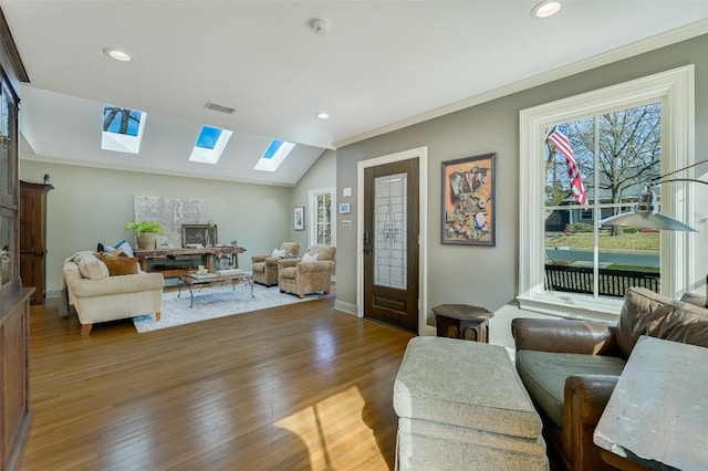 2208 Mountain View Rd, Austin, TX 78703 - living area featuring a skylight, wood finished floors, recessed lighting, ornamental molding, and baseboards
