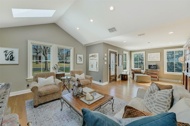 2208 Mountain View Rd, Austin, TX 78703 - living area featuring light wood finished floors, a skylight, lofted ceiling, baseboards, and recessed lighting