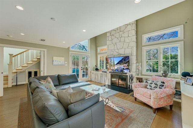 2208 Mountain View Rd, Austin, TX 78703 - living room with a fireplace, wood finished floors, stairs, plenty of natural light, and recessed lighting