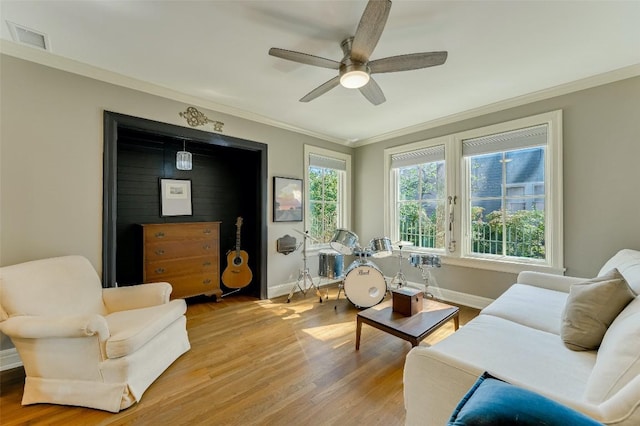 2208 Mountain View Rd, Austin, TX 78703 - living room with crown molding, wood finished floors, ceiling fan, and baseboards