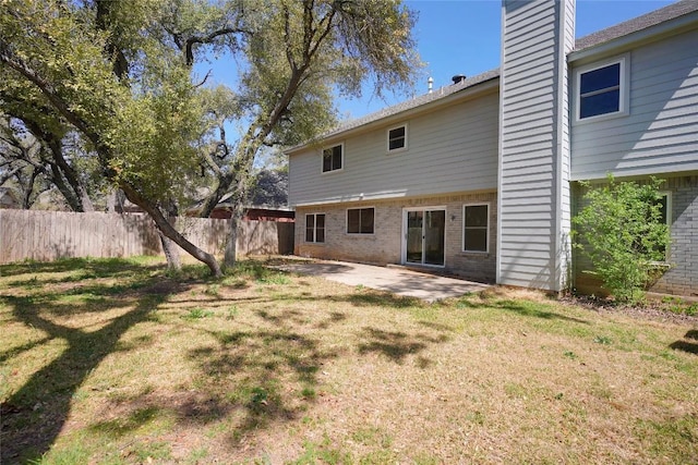 8521 Racine Trl, Austin, TX 78717 - back of property featuring brick siding, a chimney, and a patio area