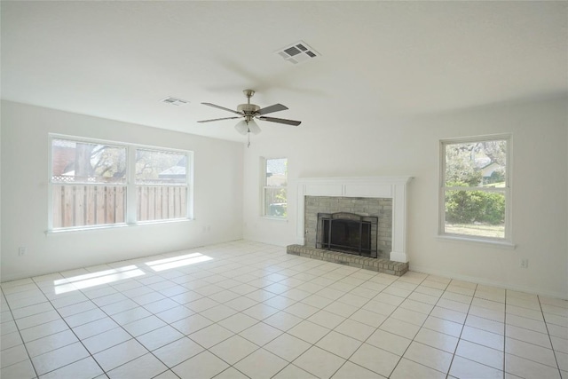 8521 Racine Trl, Austin, TX 78717 - unfurnished living room featuring plenty of natural light, ceiling fan, a brick fireplace, and light tile patterned flooring