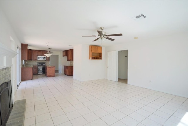 8521 Racine Trl, Austin, TX 78717 - unfurnished living room featuring a ceiling fan, a brick fireplace, and a sink