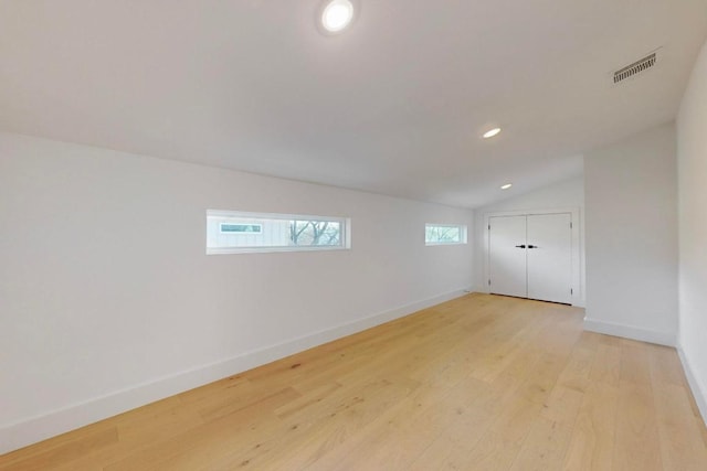 4800 Prock Ln Unit A, Austin, TX 78721 - empty room with light wood-style flooring, vaulted ceiling, baseboards, and recessed lighting