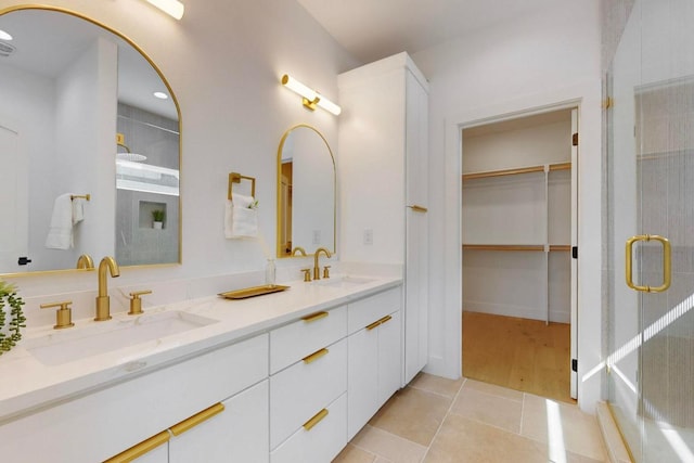 4800 Prock Ln Unit A, Austin, TX 78721 - bathroom with double vanity, tiled shower, tile patterned flooring, and a walk in closet