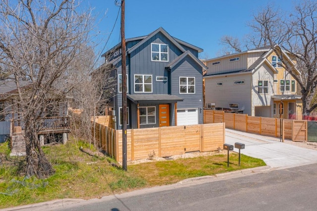 4800 Prock Ln Unit A, Austin, TX 78721 - contemporary house with board and batten siding, a garage, a fenced front yard, and concrete driveway