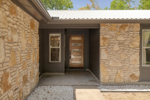 2205 Trede Dr, Austin, TX 78745 - entrance to property featuring stone siding and metal roof