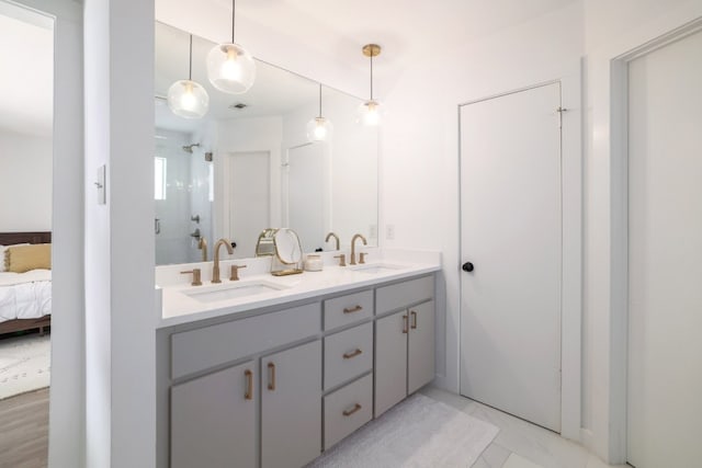 2205 Trede Dr, Austin, TX 78745 - full bath featuring double vanity, connected bathroom, an enclosed shower, and marble finish floors