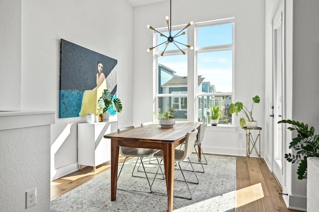 dining space featuring a chandelier and wood finished floors