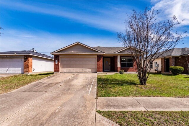 12900 Noche Clara Dr, Del Valle, TX 78617 - single story home with brick siding, a garage, concrete driveway, and a front lawn