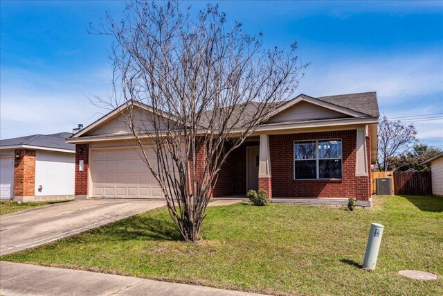 12900 Noche Clara Dr, Del Valle, TX 78617 - ranch-style house with brick siding, a garage, driveway, central AC, and a porch