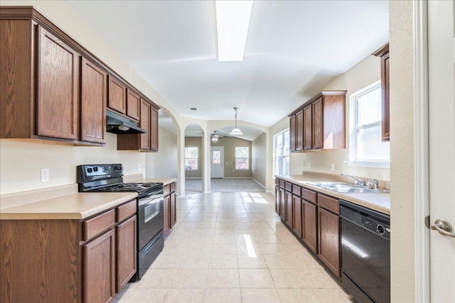 12900 Noche Clara Dr, Del Valle, TX 78617 - kitchen with black appliances, a sink, under cabinet range hood, light countertops, and light tile patterned floors