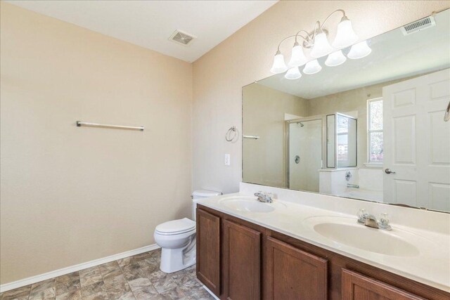 12900 Noche Clara Dr, Del Valle, TX 78617 - full bath featuring a stall shower, toilet, double vanity, and baseboards