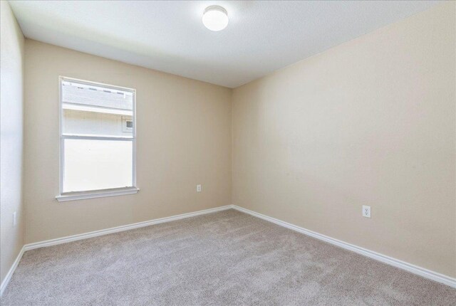 12900 Noche Clara Dr, Del Valle, TX 78617 - carpeted empty room with baseboards