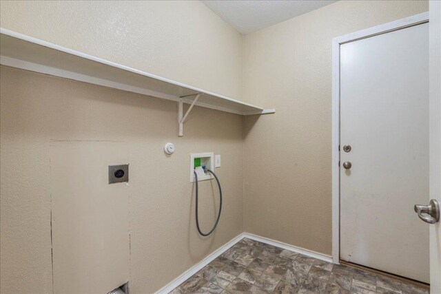 12900 Noche Clara Dr, Del Valle, TX 78617 - laundry room with hookup for an electric dryer, hookup for a washing machine, and baseboards
