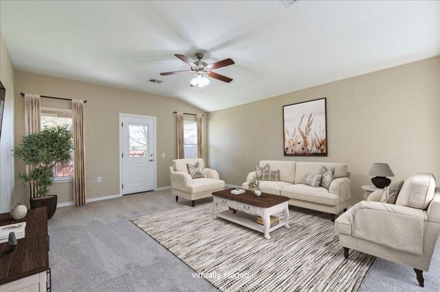 12900 Noche Clara Dr, Del Valle, TX 78617 - living room featuring a ceiling fan, light carpet, baseboards, and vaulted ceiling
