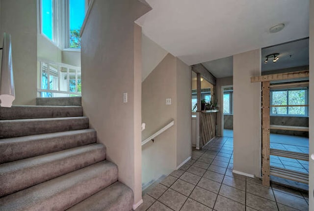 614 Sunfish St, Lakeway, TX 78734 - stairs with tile patterned flooring and baseboards