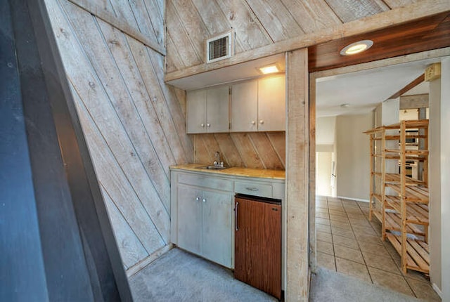 614 Sunfish St, Lakeway, TX 78734 - indoor wet bar featuring wooden walls and light tile patterned floors