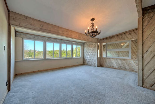 614 Sunfish St, Lakeway, TX 78734 - carpeted empty room with a chandelier and wooden walls