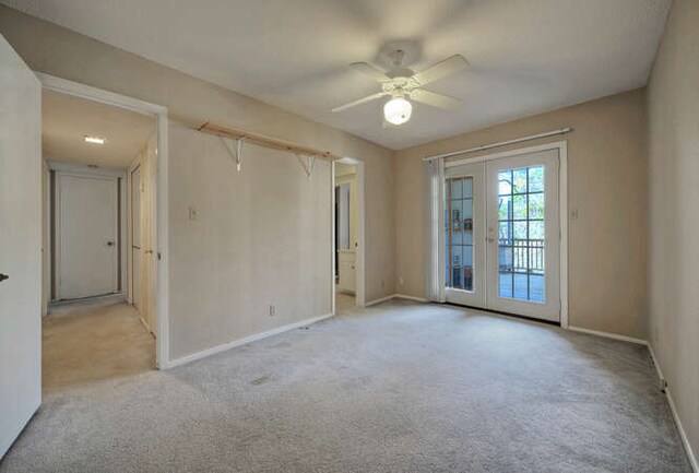 614 Sunfish St, Lakeway, TX 78734 - spare room featuring carpet floors, baseboards, french doors, and a ceiling fan