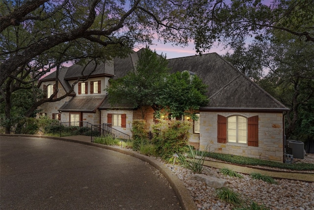4403 Elohi Dr, Austin, TX 78746 - view of front of house with stone siding and a shingled roof