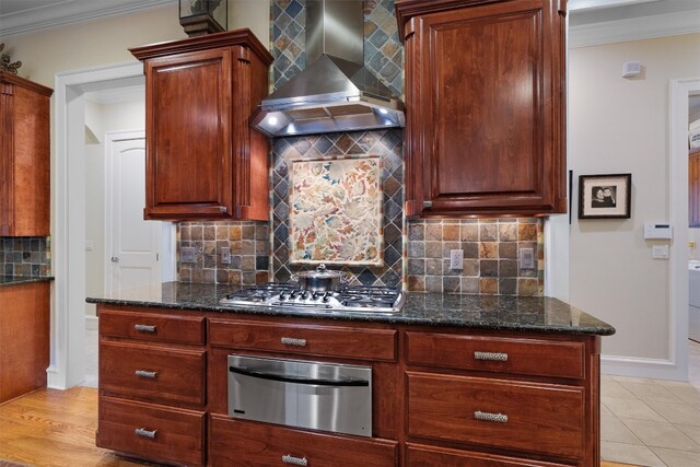 4403 Elohi Dr, Austin, TX 78746 - kitchen featuring wall chimney exhaust hood, a warming drawer, stainless steel gas stovetop, tasteful backsplash, and ornamental molding