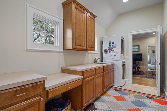 4403 Elohi Dr, Austin, TX 78746 - laundry area with estacked washer and dryer, cabinet space, recessed lighting, and light tile patterned floors