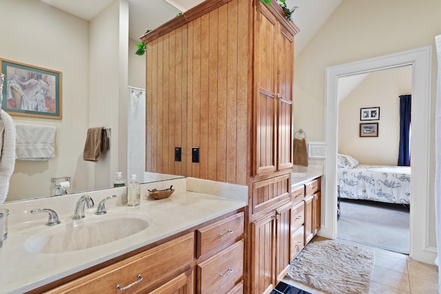 4403 Elohi Dr, Austin, TX 78746 - bathroom with lofted ceiling, vanity, tile patterned floors, and connected bathroom