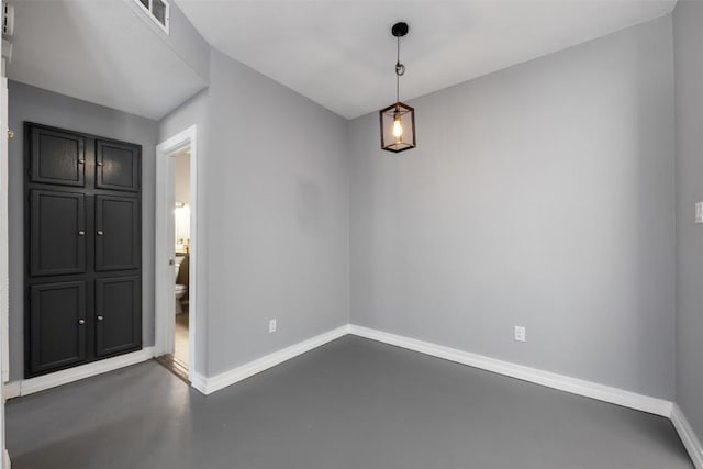 2450 Wickersham Ln Unit 101, Austin, TX 78741 - unfurnished dining area featuring baseboards and finished concrete flooring