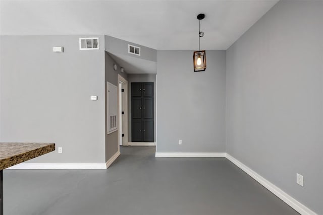2450 Wickersham Ln Unit 101, Austin, TX 78741 - unfurnished dining area featuring visible vents, baseboards, and finished concrete flooring