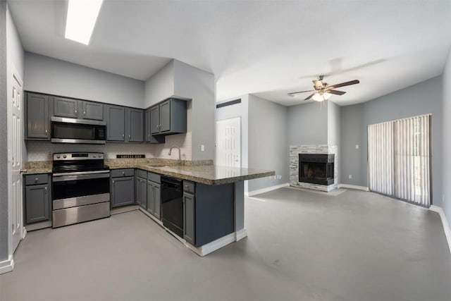 2450 Wickersham Ln Unit 101, Austin, TX 78741 - kitchen featuring a peninsula, gray cabinets, ceiling fan, a sink, and appliances with stainless steel finishes