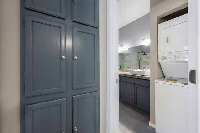 2450 Wickersham Ln Unit 101, Austin, TX 78741 - full bathroom with vanity, stacked washer and dryer, and tiled shower