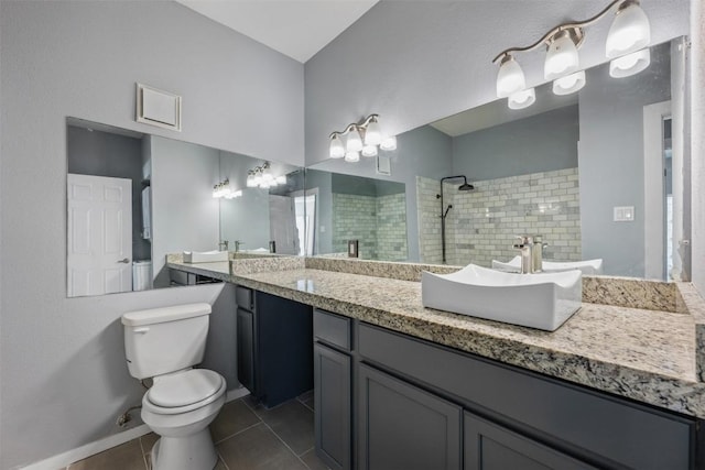 2450 Wickersham Ln Unit 101, Austin, TX 78741 - full bathroom featuring toilet, a sink, a tile shower, tile patterned flooring, and double vanity