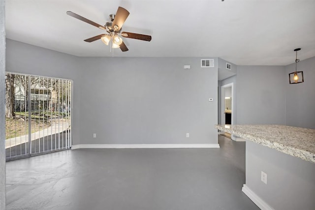 2450 Wickersham Ln Unit 101, Austin, TX 78741 - unfurnished living room with visible vents, baseboards, ceiling fan, and finished concrete floors