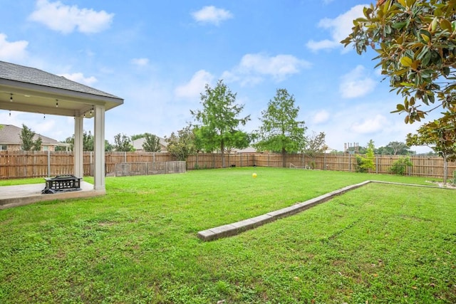 view of yard featuring a patio area, a fire pit, and a fenced backyard