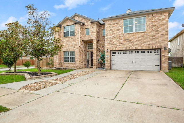 traditional-style home featuring fence, an attached garage, brick siding, and driveway
