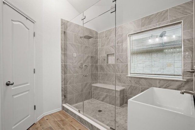 full bath featuring a shower stall and wood finished floors