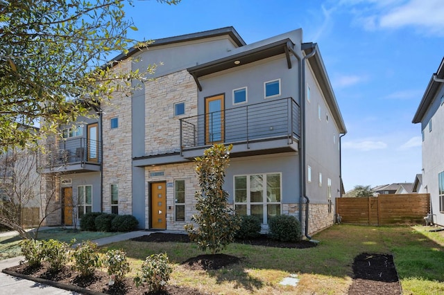 5809 Charles Merle Dr Unit B, Austin, TX 78747 - view of front facade featuring a balcony, stone siding, and stucco siding