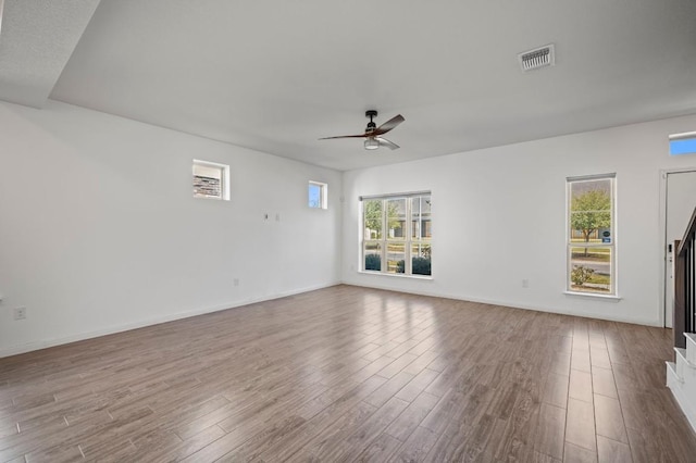 5809 Charles Merle Dr Unit B, Austin, TX 78747 - unfurnished living room with ceiling fan, wood finished floors, and baseboards
