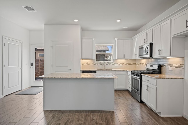 5809 Charles Merle Dr Unit B, Austin, TX 78747 - kitchen featuring stainless steel appliances, a sink, a kitchen island, dark wood-style flooring, and recessed lighting